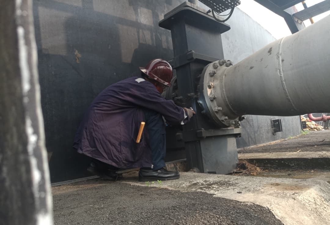 Engineer performing maintenance on industrial oil and gas equipment